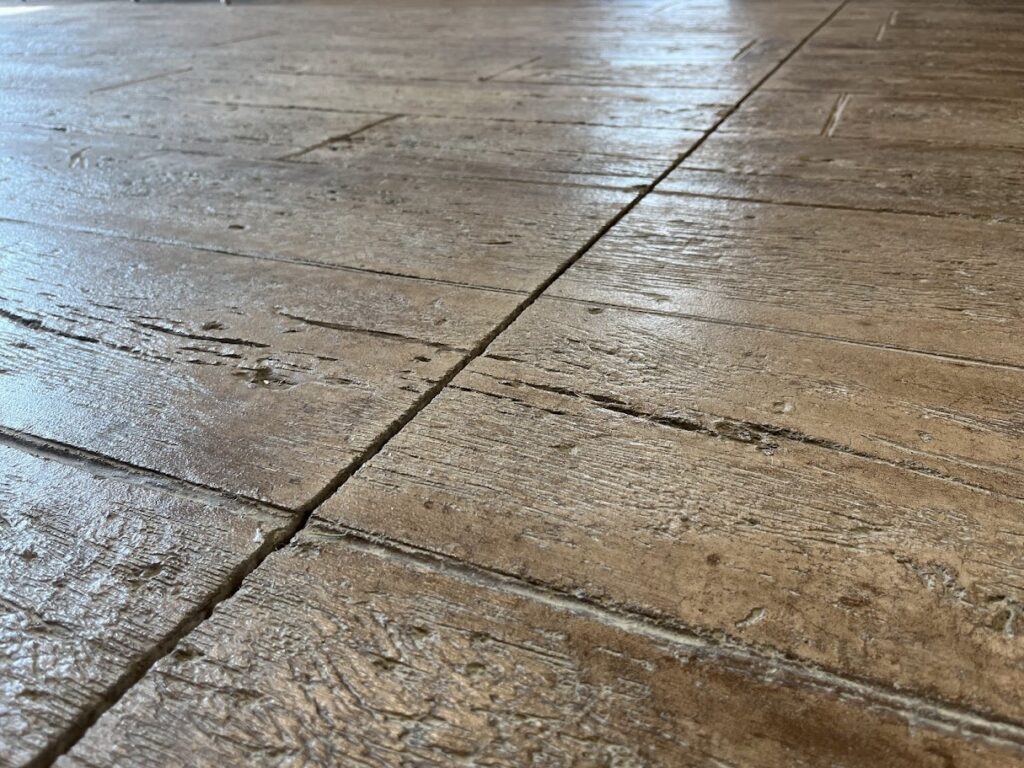 saw-cut concrete control joints in a residential driveway