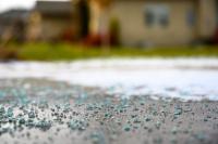 ice melt pellets scattered on concrete driveway surface in winter