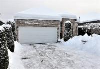 snow-covered driveway and garage after winter storm