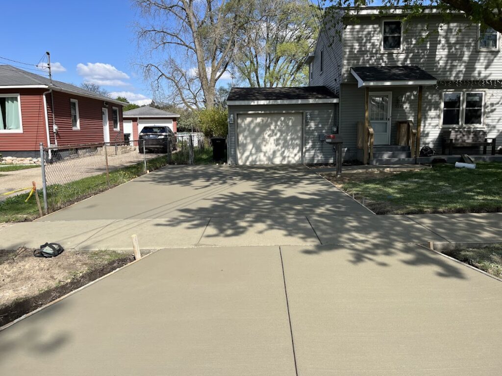 Newly finished concrete driveway providing expanded parking space and improved safety
