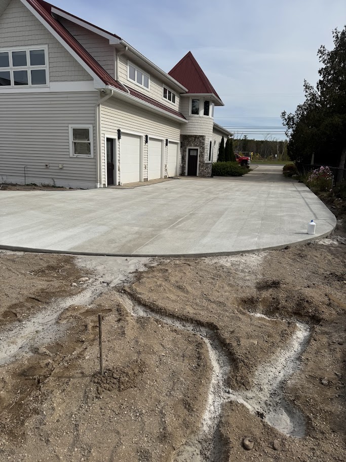 Wide concrete driveway completed for a large lakeside cottage in Beulah, Michigan