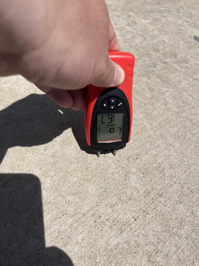 Using a moisture meter on concrete during a repair evaluation