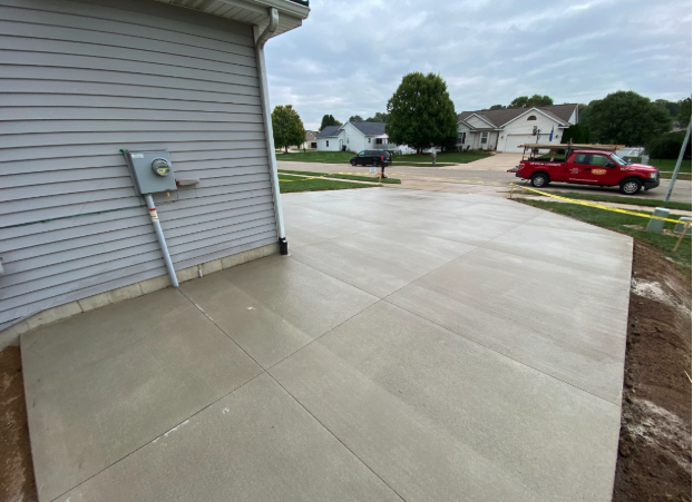 Finished concrete driveway with planned control joints near a garage